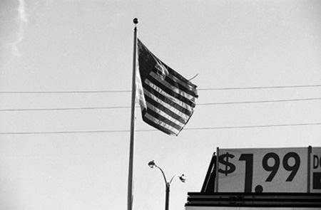 Tattered American flag, sign reading: $1.99, Porterville, Calif. 1992